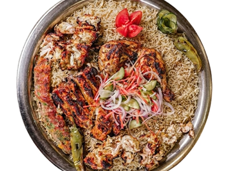 BBQ Feast Platter, Malai Boti, flame-grilled Leg Tikka and a duo of Chicken & Beef Kebabs, served with seasoned rice, fresh vegetables and signature sauces, Sufraq Karachi